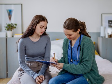 Teen girl talking to doctor