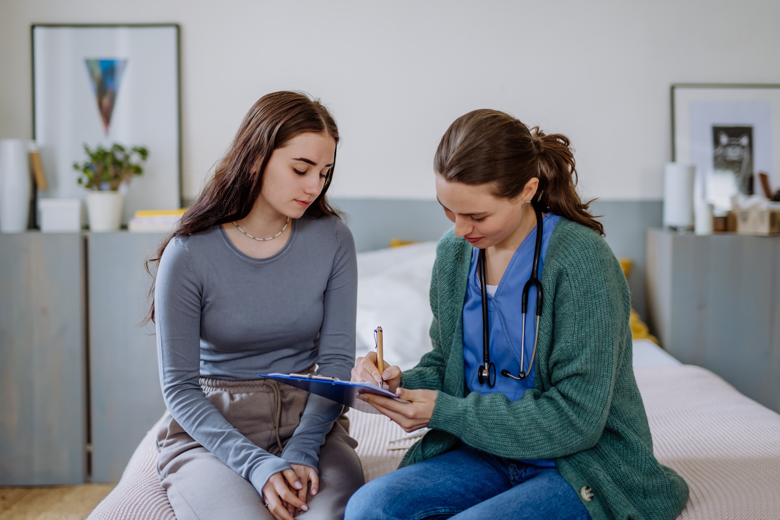 Teen girl talking to doctor