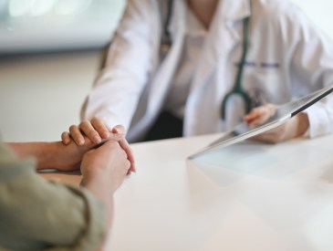 Doctor showing a patient some information on a digital tablet