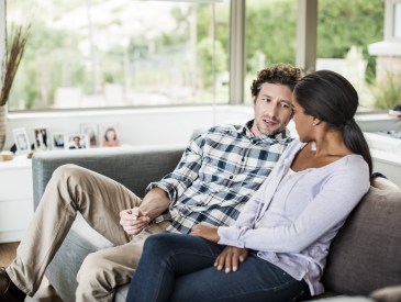 Couple relaxing on sofa at home