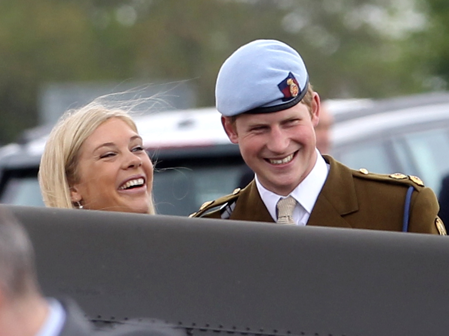 Prince Harry and Chelsy Davy laugh as they attend Prince Harry's Pilot Course Graduation at the Army Aviation Centre on May 7, 2010 in Andover, England.