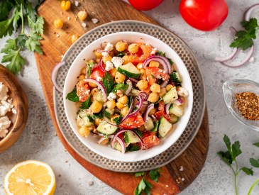 Chickpea salad with tomatoes, cucumber, feta cheese, parsley, on