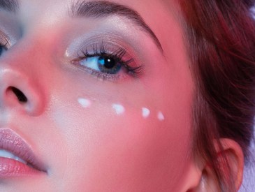 Woman using eye cream, like THESAEM's Iceland Hydrating Peptide Eye Stick