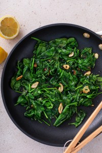 Sauteed spinach with garlic in a skillet, healthy side dish idea