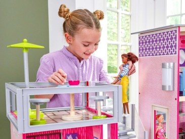girl playing Barbies, dollhouse