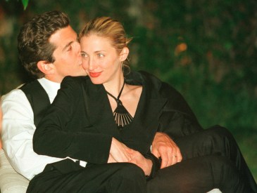 John F. Kennedy, Jr. editor of George magazine, gives his wife Carolyn Bessette Kennedy a kiss