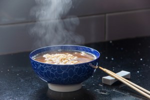 steam coming from a freshly made bowl of instant noodle soup.