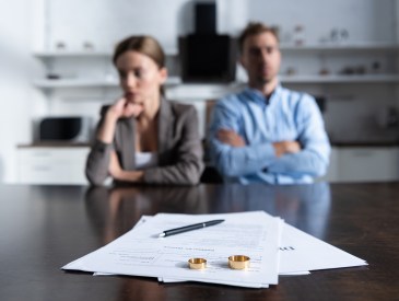Couple sitting at table with divorce documents