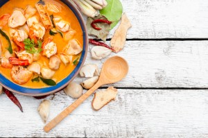 Thai food, River prawn spicy soup on wooden table or " Tom Yam Kung " on white wooden table background.