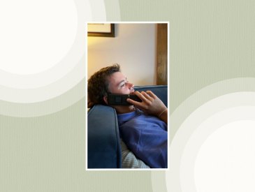 College-aged teen boy talking on a flip phone