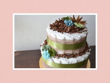 Diaper cake wrapped in burlap coth and green ribbons.