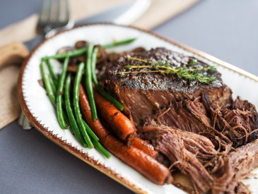 Slow cooked beef roast with carrots and green beans with thyme