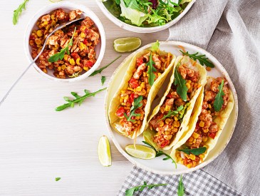 Mexican tacos with chicken meat, corn and tomato sauce. Latin American cuisine. Taco, tortilla, wrap. Top view. Flat lay