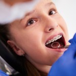 Girl with braces during a routine, dental examination
