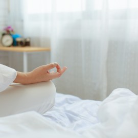 woman doing yoga in bed
