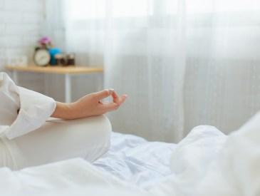 woman doing yoga in bed