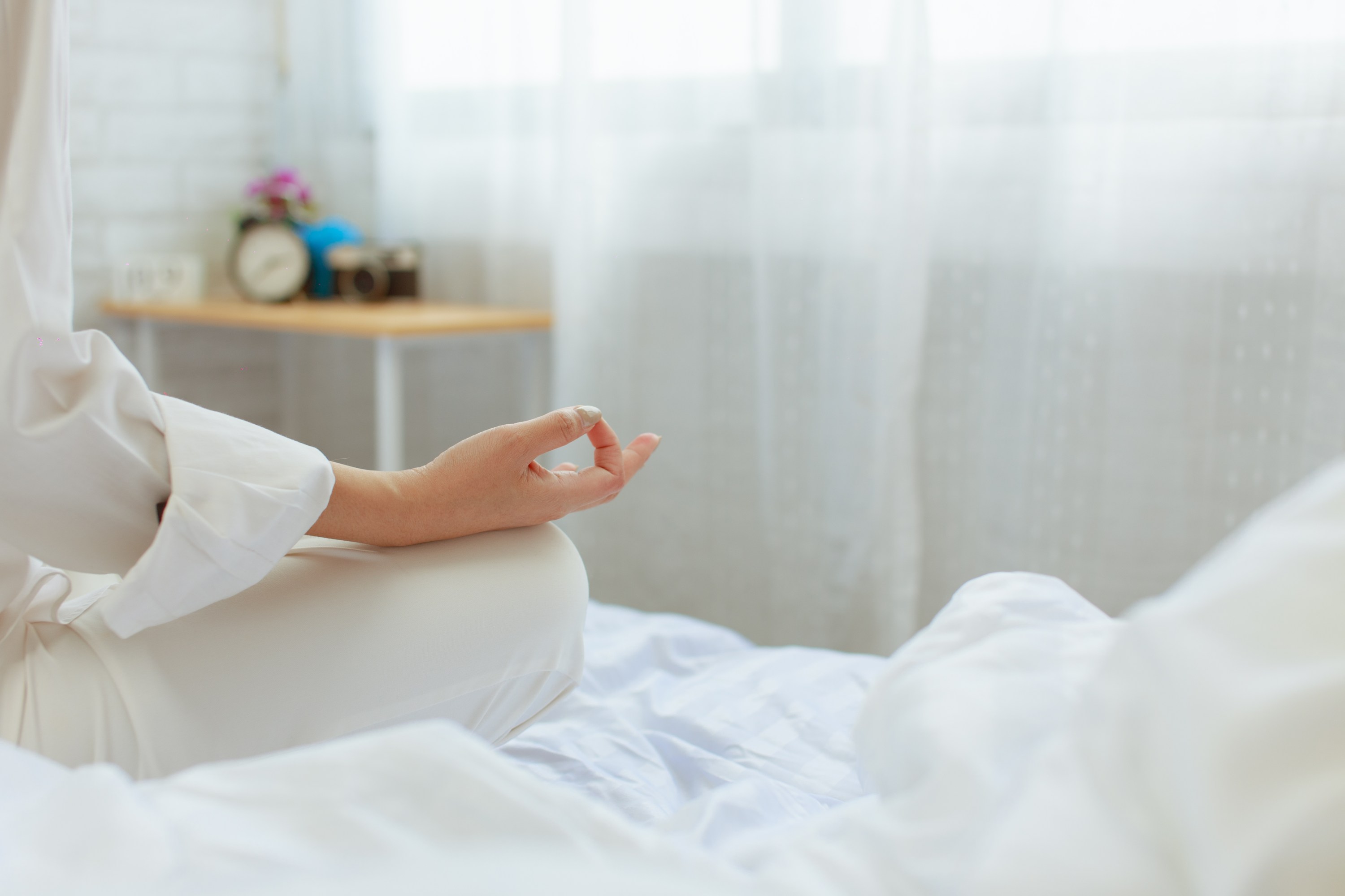 woman doing yoga in bed