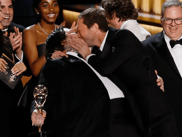 Matty Matheson and Ebon Moss-Bachrach kiss with the cast of The Bear at the 75th Primetime Emmy Awards at the Peacock Theater in Los Angeles, CA, on Monday, Jan. 15, 2024.